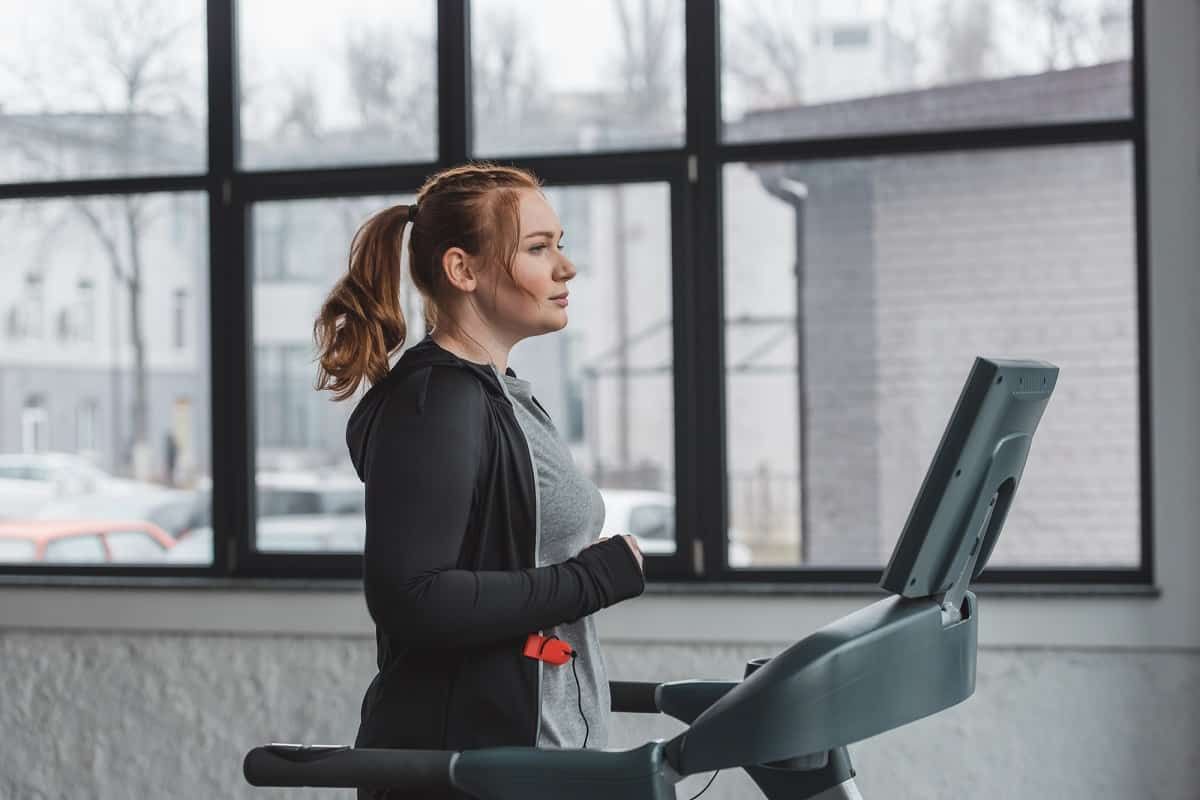 Person starting a beginner treadmill workout with proper form